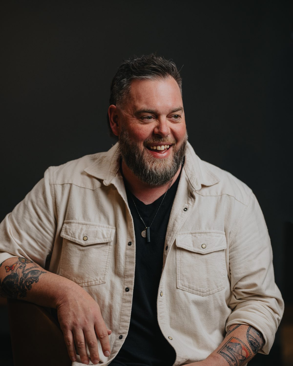 Drew Powell laughing in conversation