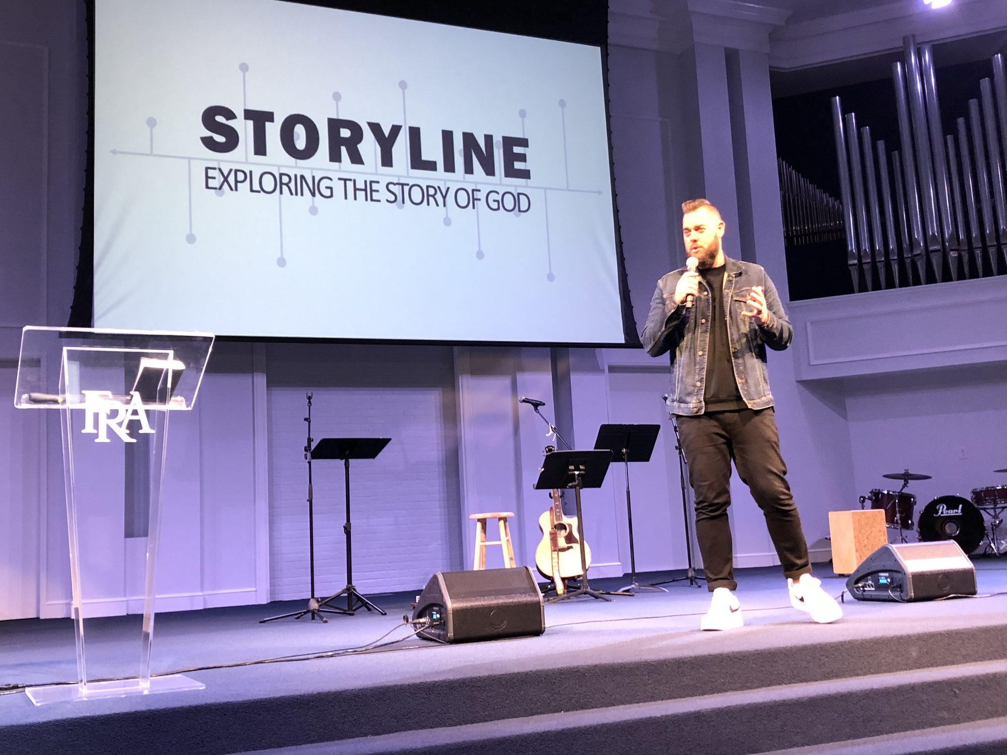 Drew Powell teaching from a church stage